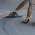 person spreading epoxy flooring